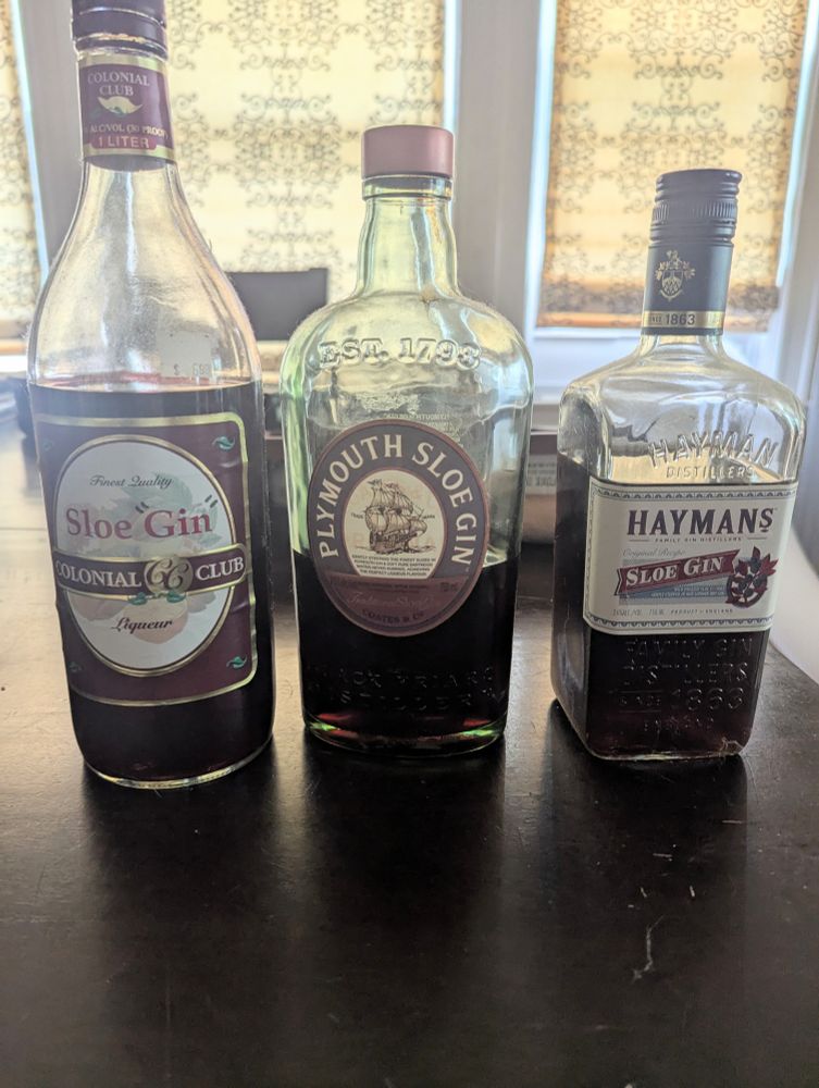 Three bottles of sloe gin are lined up on my table. The first one is Colonial Club and it cost six dollars, and someone drew scare quotes around the word gin. The other two bottles are from respected brands, Plymouth and Haymans.