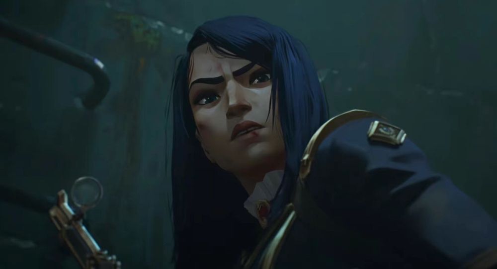 Arcane character Caitlyn Kiramman at the end of Season 2 Episode 3. she has a bloodied lip and face and her long blue hair is down and messy. she's in her navy blue Enforcer uniform and holding her Hextech rifle. she's looking down at Vi (not pictured) looking angry, shocked, sad. 