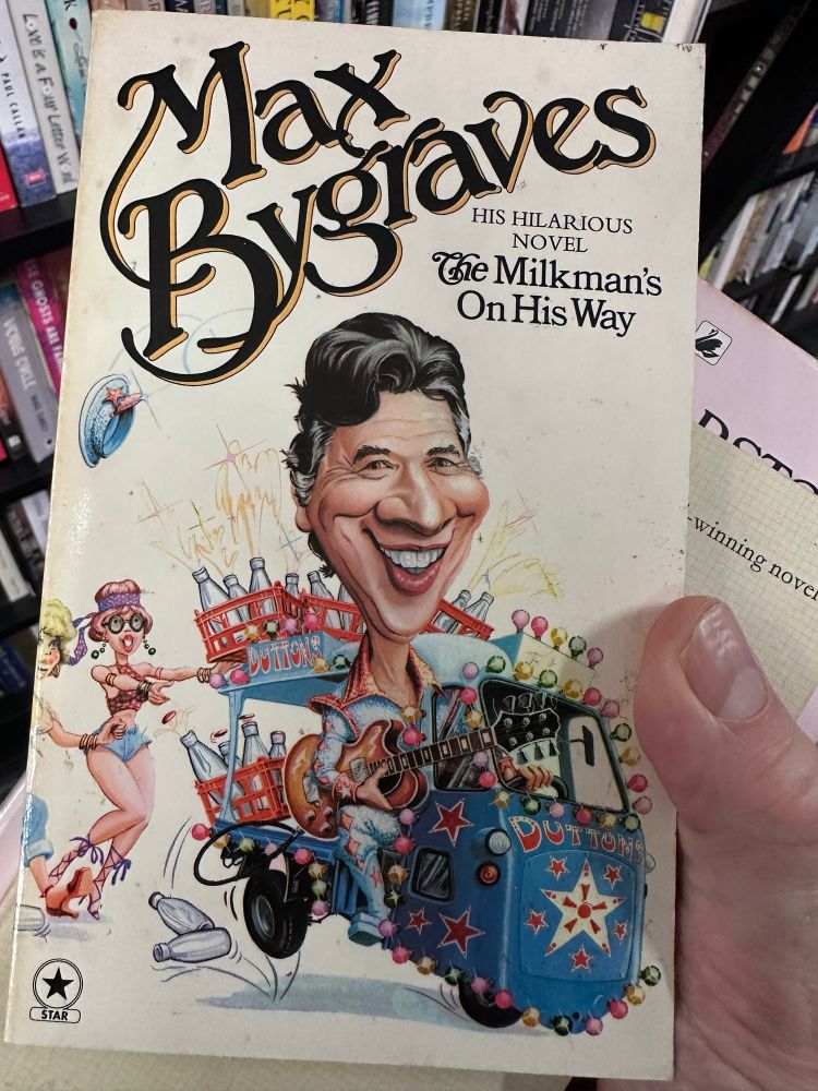 Cover of the novel, showing a caricature of a man who looks very like Max Bygraves driving a milk float and being pursued by a scantily clad young woman