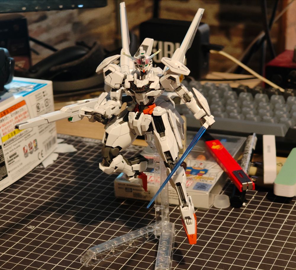 A asambled and panel lined High Grade Gundan Calibarn model kit on a messy desk