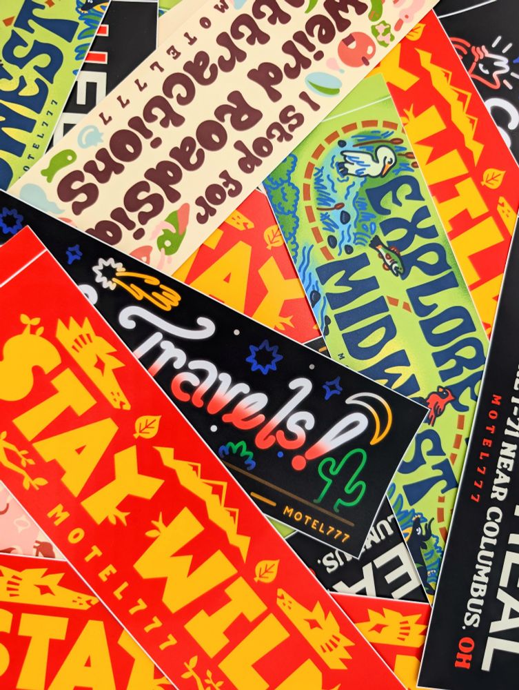 Various bumper sticker designs, in a pile.