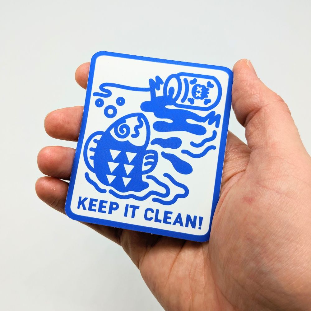 A Keep It Clean sticker being held.