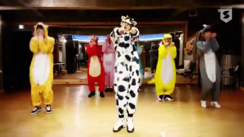 a group of people wearing animal costumes are dancing