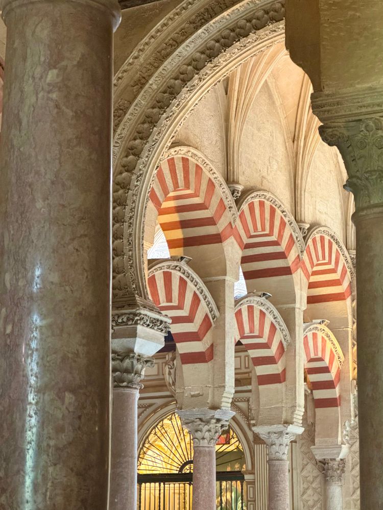 Cream and red-colored double arches inside the mosque portion of the Grand Mosque-Cathedral in Cordoba, Spain.  