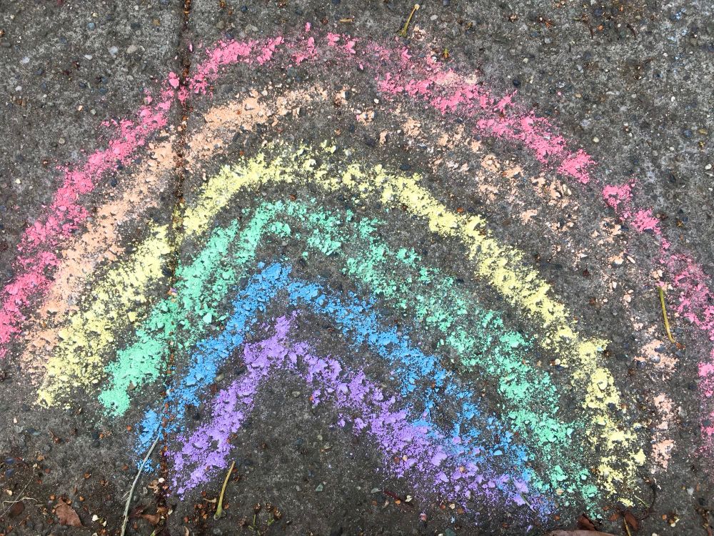 Pride month rainbow drawn in chalk on sidewalk