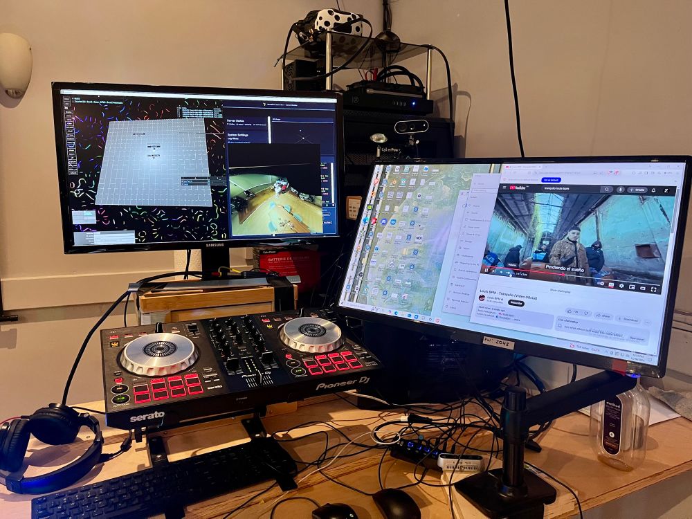 DJ turntables and multiple monitors. The song Tranquilo by Louis BPM is playing on a YouTube window. 
