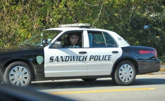 Photo of a Sandwich police cruiser taken from inside a vehicle. 