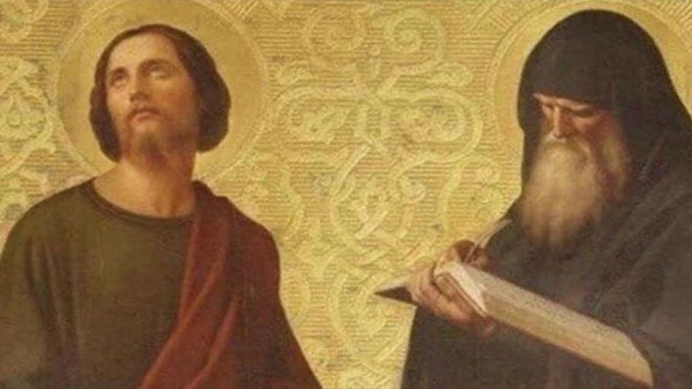 The image depicts two figures: one resembles Christ with a halo, looking upward, and the other appears to be a bearded monk or scribe, looking at a book. The background features intricate patterns.