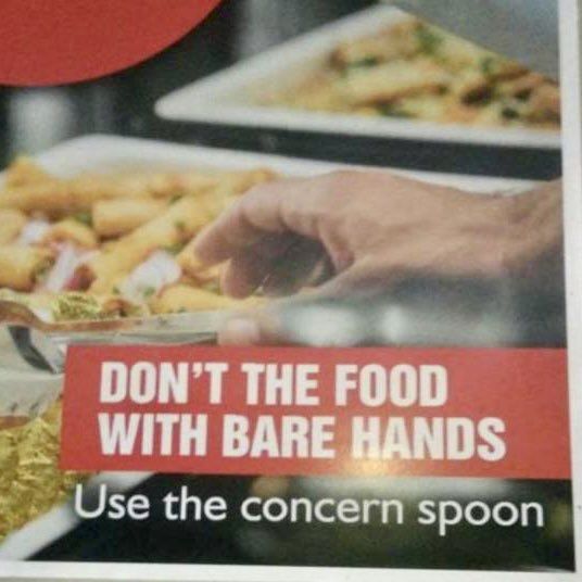 Poster by buffet reads "DON'T THE FOOD WITH BARE HANDS - Use the concern spoon."