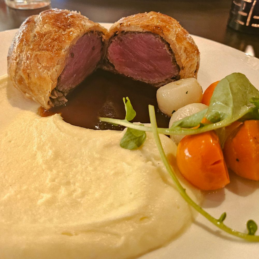 beef wellington, potato puree, and roasted vegetables