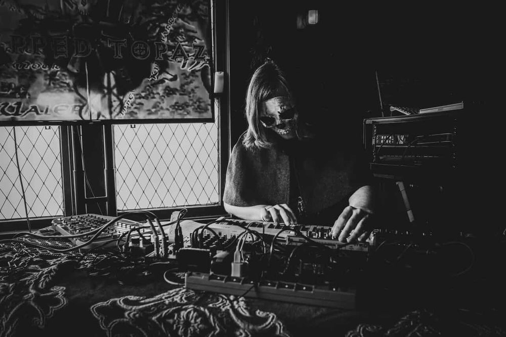 Black and white photo of dungeon synth artist Chipped Topaz performing at Texas Dungeon Siege