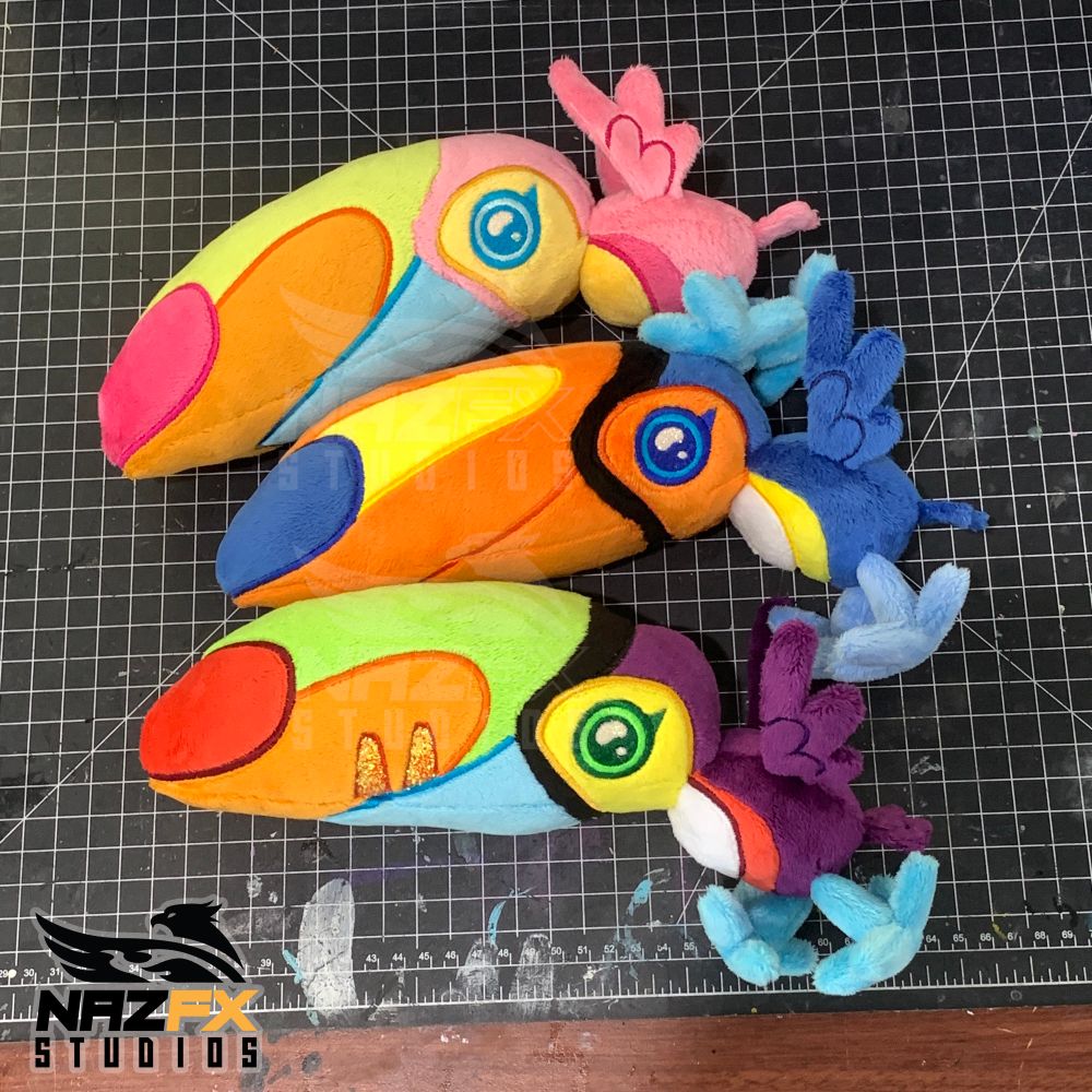 3 handmade toucan plush. They have a huge head and a tiny body. Each is a rainbow of colors 