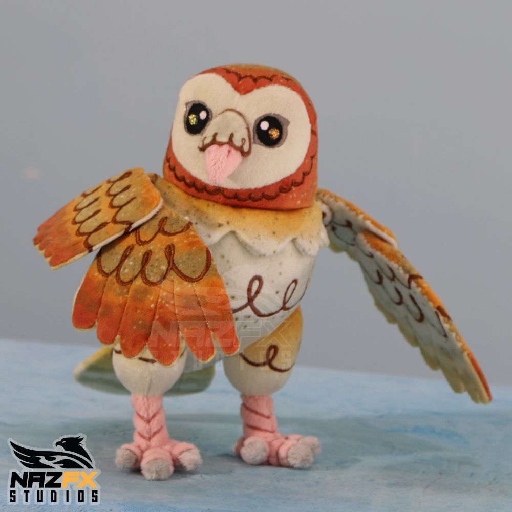 A cute handmade owl plushie. It is based on a barn owl