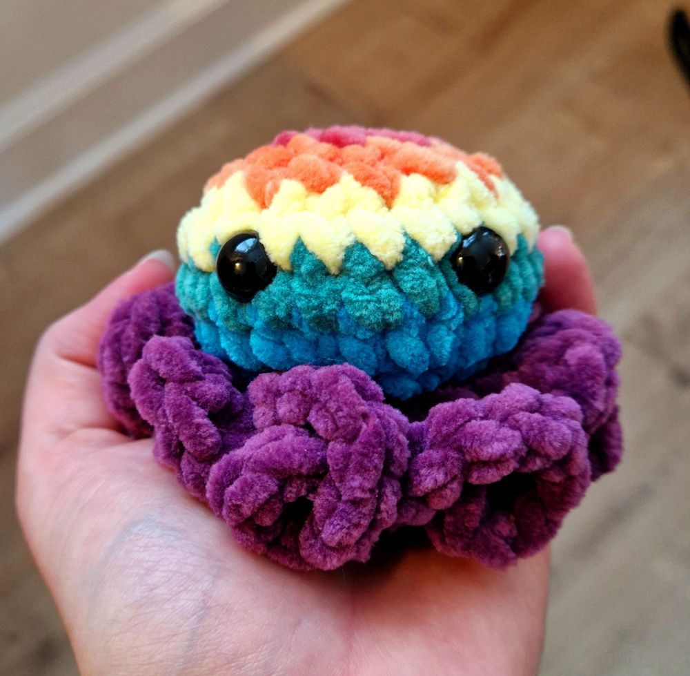 Crocheted octopus with curly arms (from the Curly Kraken pattern) in rainbow colors