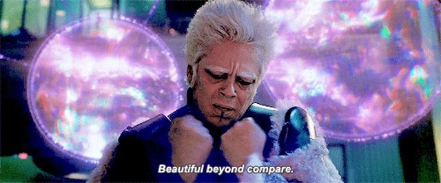 a man with white hair says " beautiful beyond compare " in front of a purple background