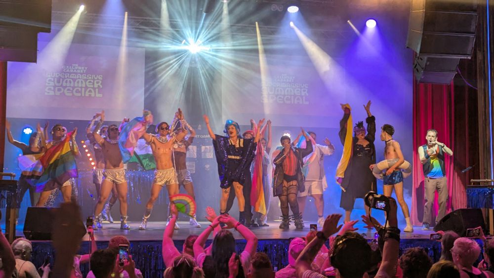 The cast of the Gallifrey Caberet last night all on stage with various pride flags 