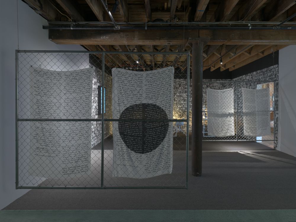 A gallery shot featuring two fences draped with fabric.