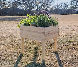 A raised garden bed made of wood and on legs.