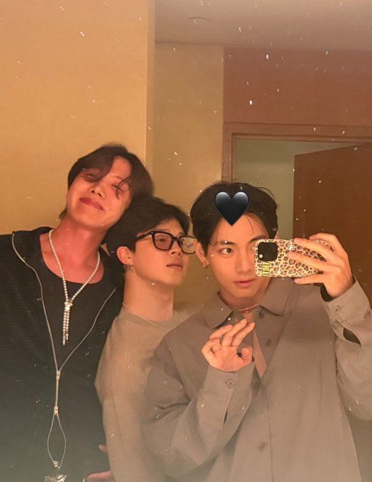 A mirror selfie of Taehyung of BTS in a grey button up with Jimin and J-hope of BTS posing and looking adorable and comfortable