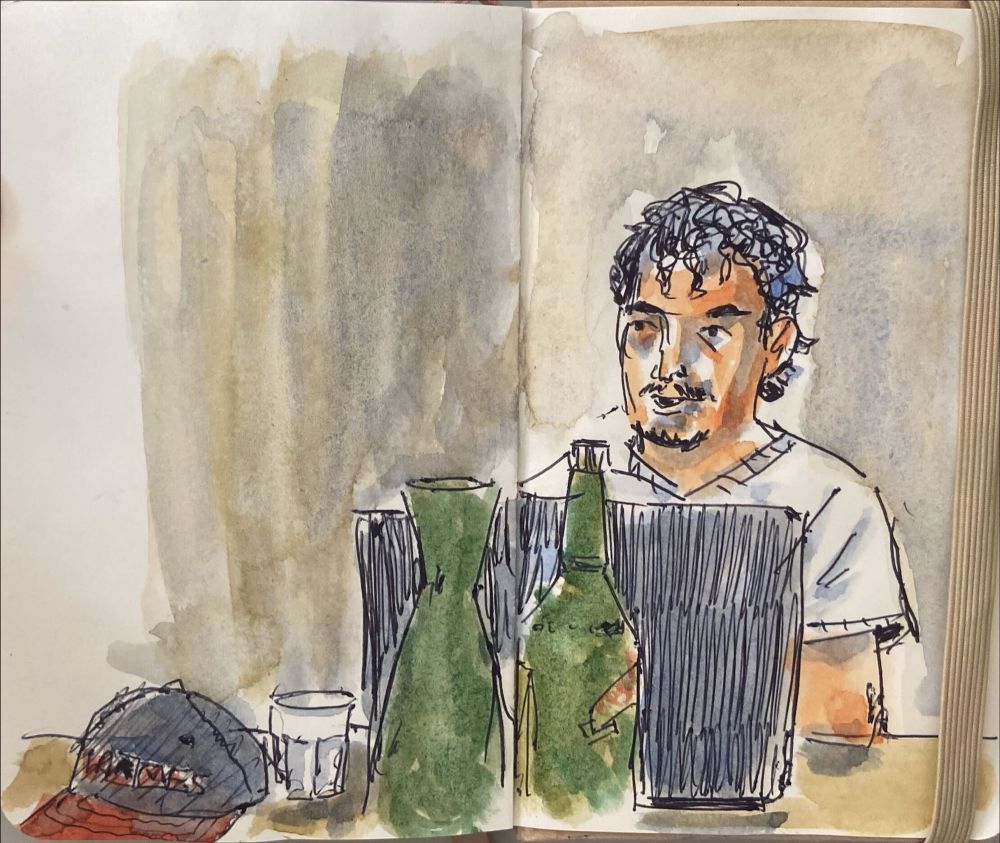 A loose ballpoint pen and watercolor sketch of a young guy with curly hair