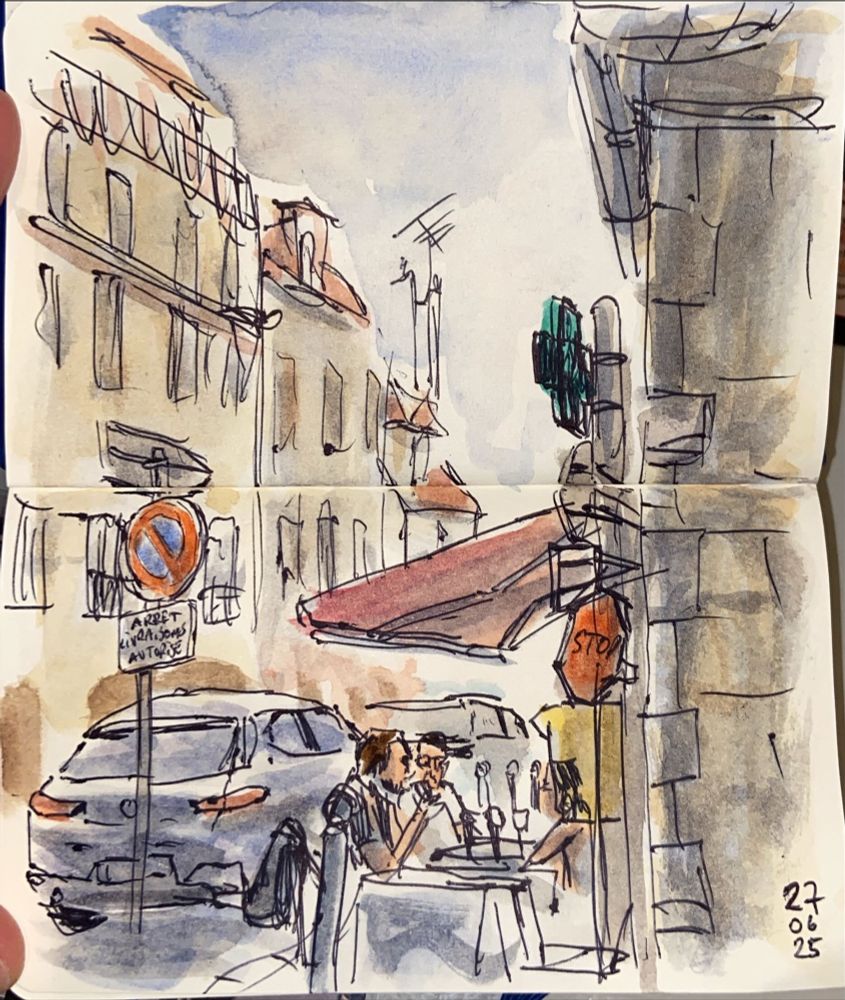 A watercolor and ballpoint pen sketch. We see a French stream with a car parked and some people eating on the terrace of a restaurant.