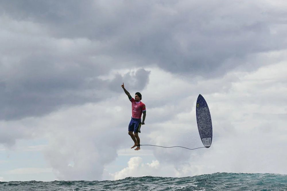 surfer standing in air, with board even with him