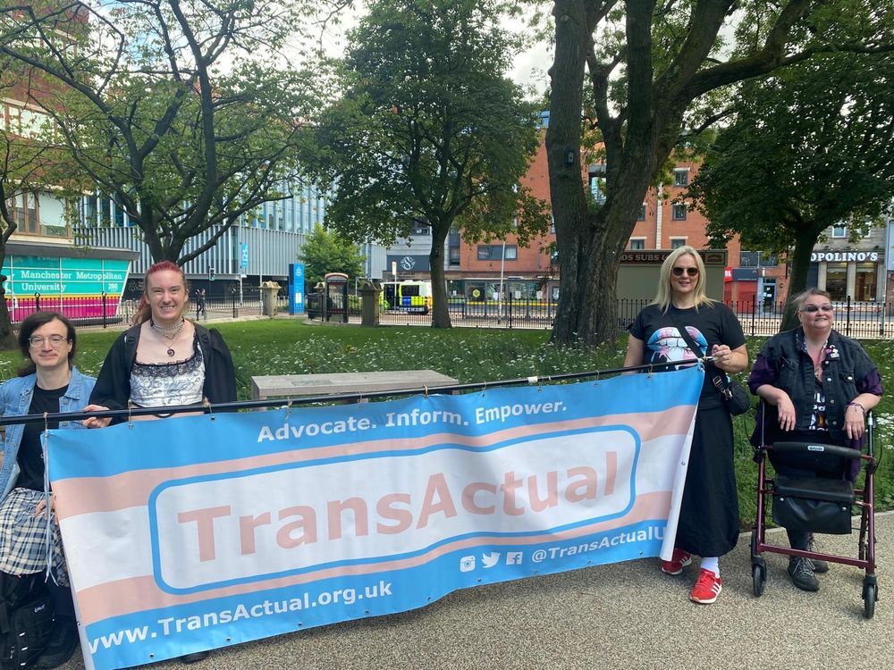 Photo of some people holding the big TransActual banner.