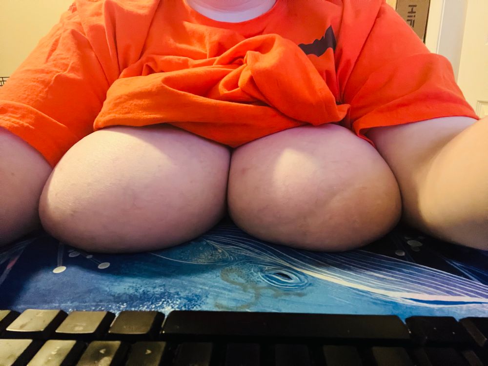 Hex sitting at their desk with they bare tits on the desk. 