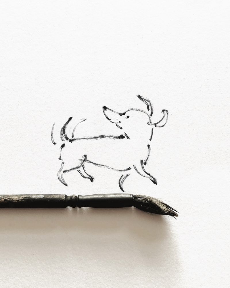 Brush and ink sketch by Emma Quay of a dog walking along a paintbrush, looking back over its shoulder.