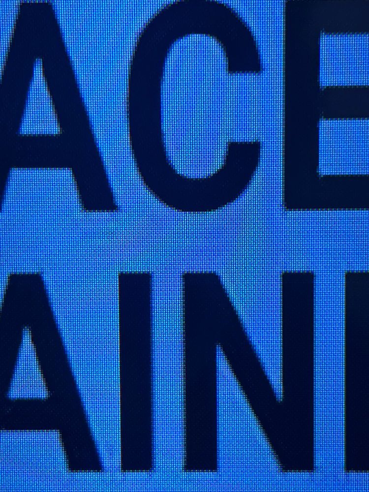 Letters on a TV screen showing overshoots from compression. Transform artifacts