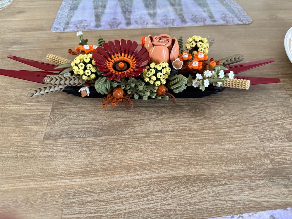 Lego flower table piece in browns oranges yellows maroons and white