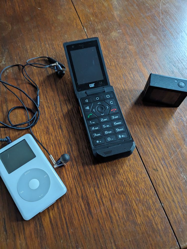 An iPod, a dumb phone and an action camera