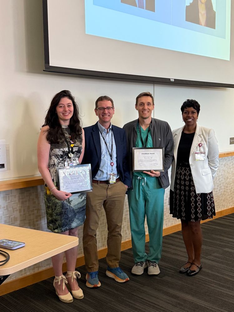 Taylor Karl, MD and Thomas Enke, MD are presented with the Dr. Marshall Freedman award by Drs. Jennifer Christie and Frank Scott.