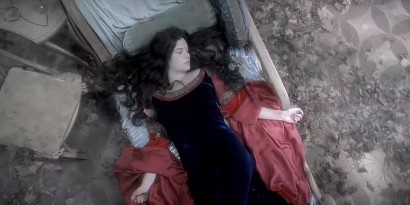 Arwen from lord of the rings laying down on this weird lounging couch bed thing 