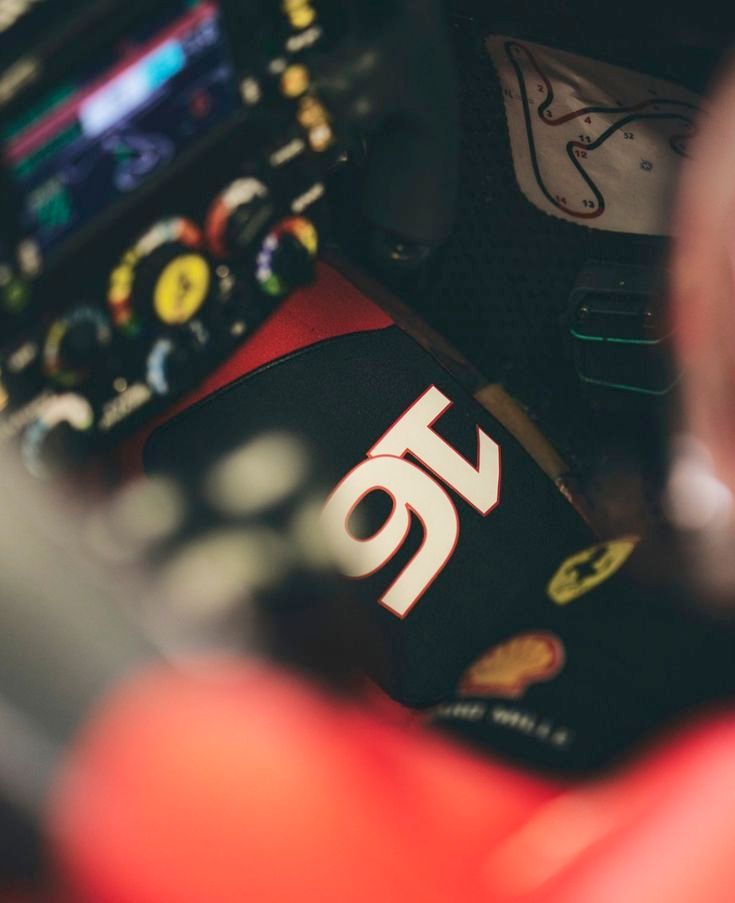 a close up of charles leclerc's steering wheel and gloves