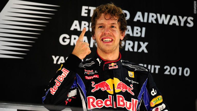 Sebastian Vettel raises one finger on the podium