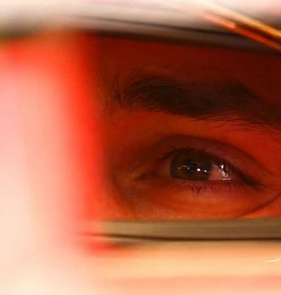 close up shot of charles leclerc's eyes looking out from his helmet 
