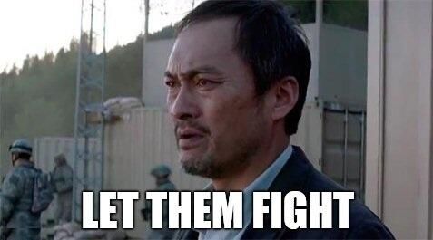 A screencap from a godzilla movie with the white text "Let Them Fight" at the bottom. 