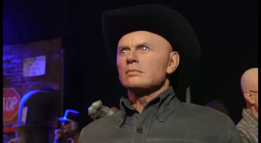 a man wearing a cowboy hat has a robotic face coming out of his mouth