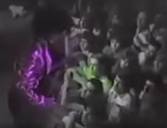 Prince in purple seen from above with a few rows of fans from the Aug. 3, 1983 concert at First Avenue. 