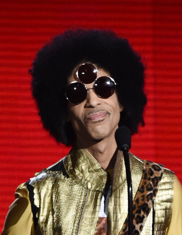 Prince wearing sunglasses that have a third lens on his forehead