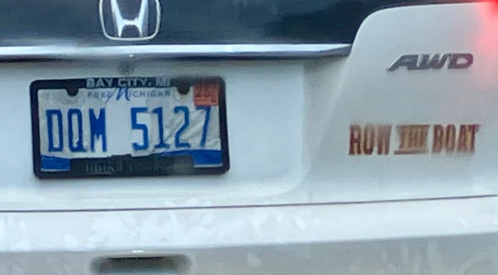 Michigan license plate with maroons and gold Row the Boat sticker