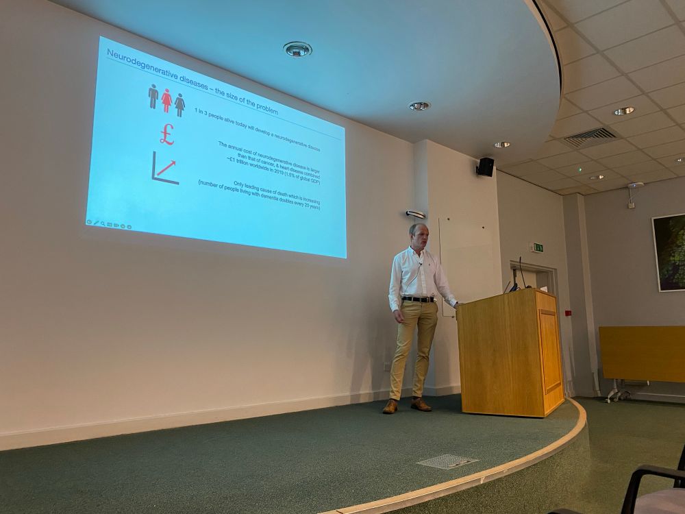 Prof Horrocks standing in front of his presentation, introducing the need for sensitive diagnostics in neurodegenerative disease.
