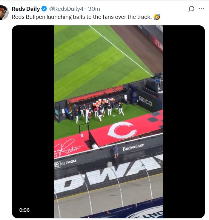 Reds Bullpen launching balls to the fans over the track.