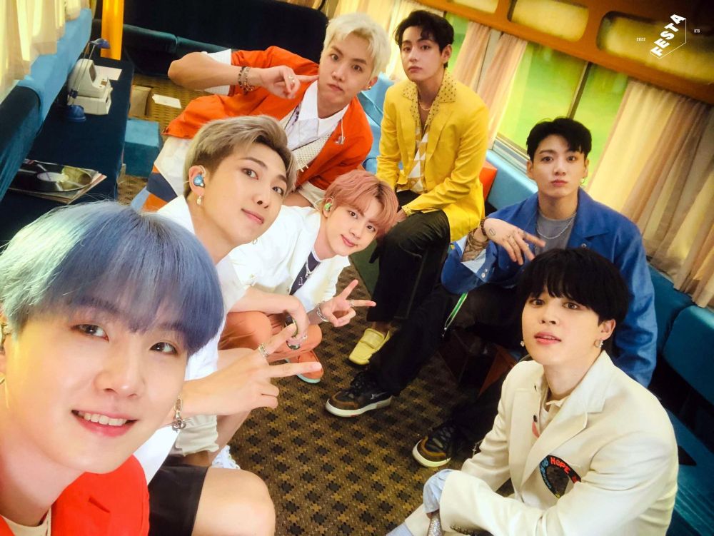 bts ot7 in 2021 for their butterful getaway comeback special. they're inside an RV, dressed in suits of bright orange, yellow, or blue, looking cute. jimin has that bowl cut that i think is actually SO chic and sexy, and taehyung is wearing yellow loafers.