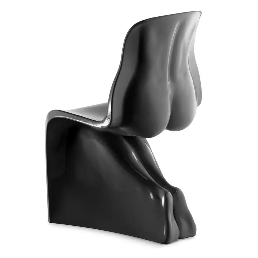a matte black plastic chair with the back sculpted to look like a bare female torso with feet down in a kneeling position