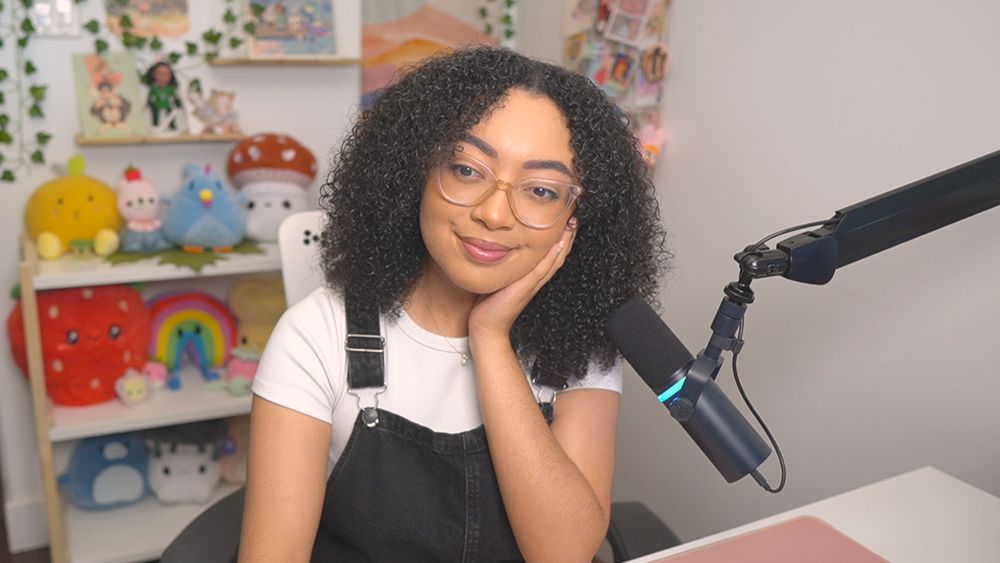 sheilur smiling at the camera sitting at her stream set up