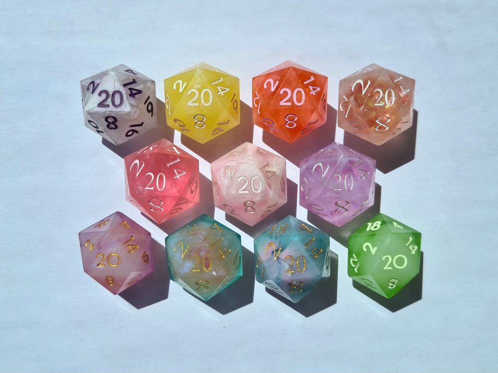 Eleven twenty-sided dice of various colors
