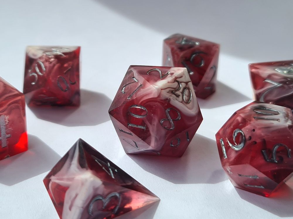 Dark red and white dice set with dark silver numbers on a white background