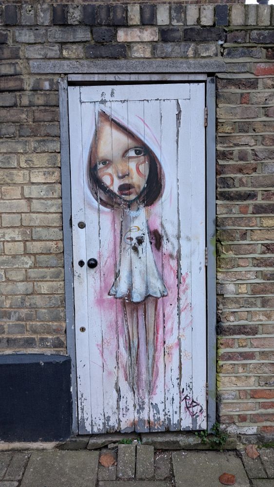 Painted character on wooden door. 